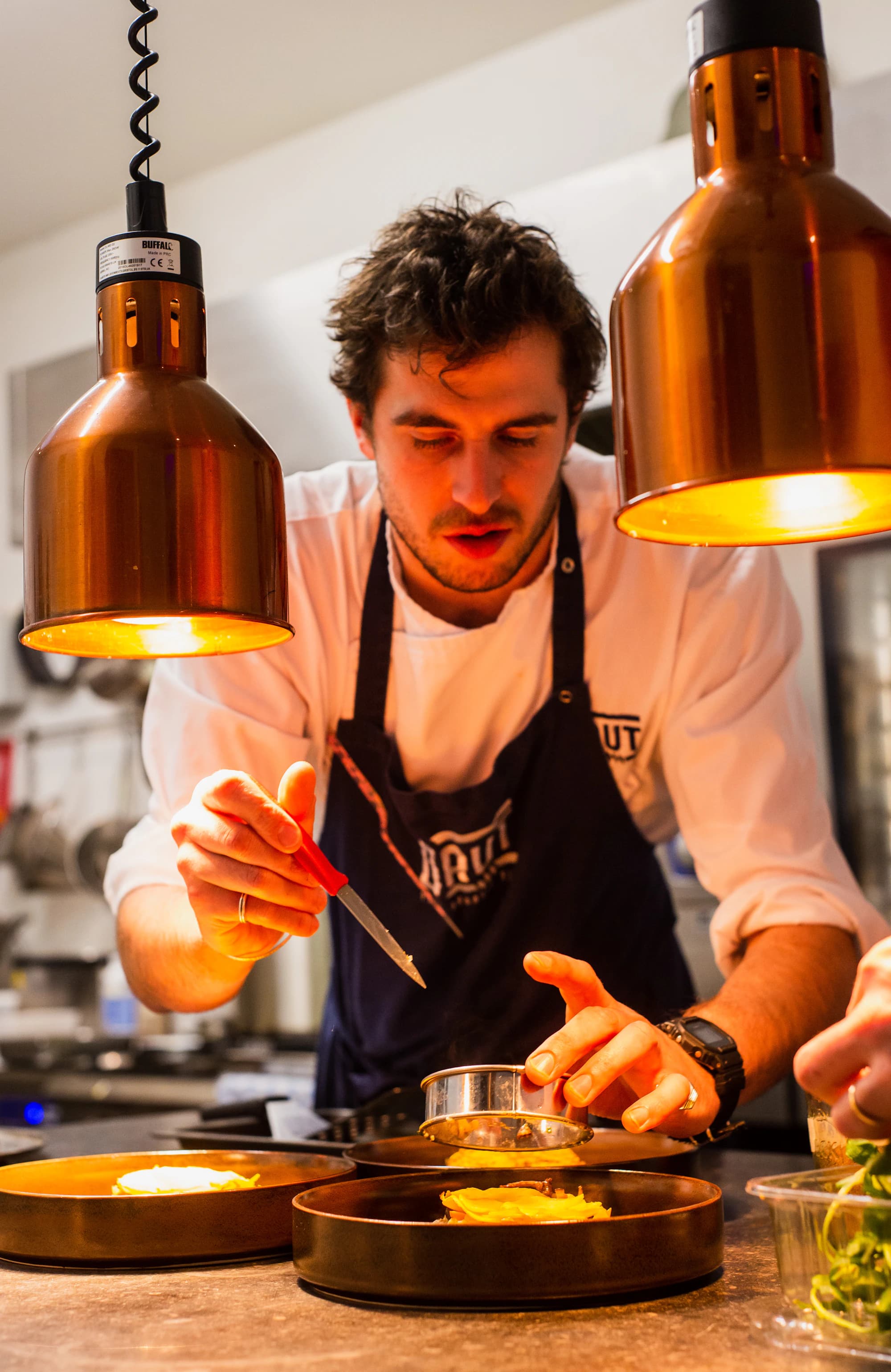 A chef plating a dish during service