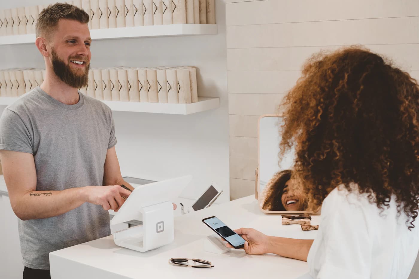 A merchant serving a customer at the counter