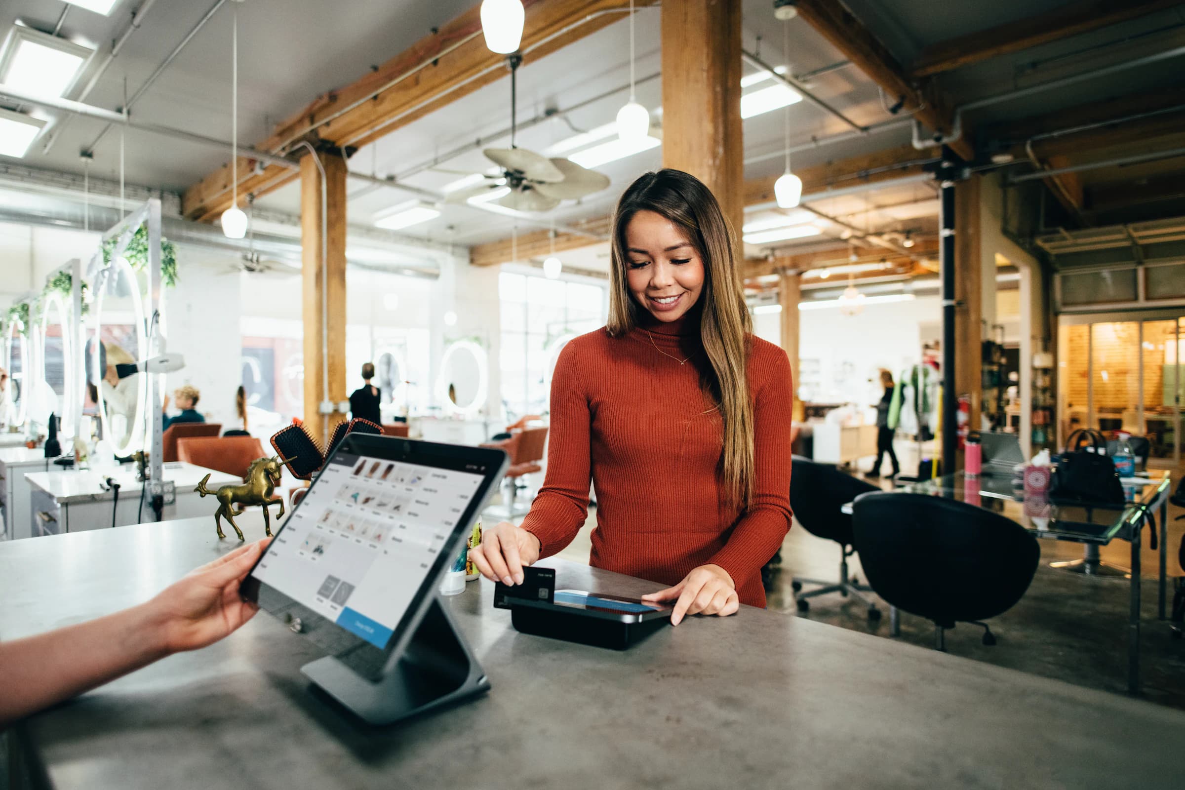 A merchant taking an order on a tablet